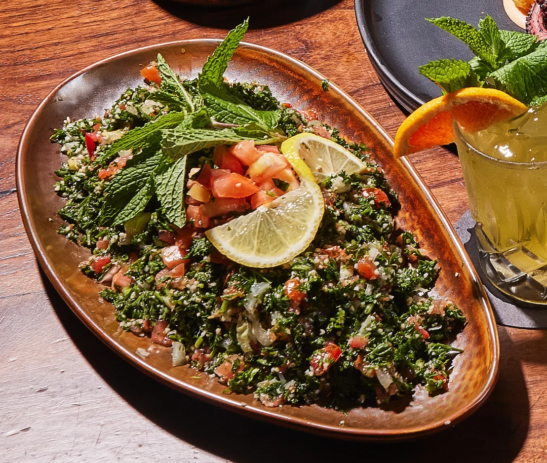 Tabbouleh Salad with roasted beef lettuce, chopped tomatoes, onion, pickles, and tahini sauce.