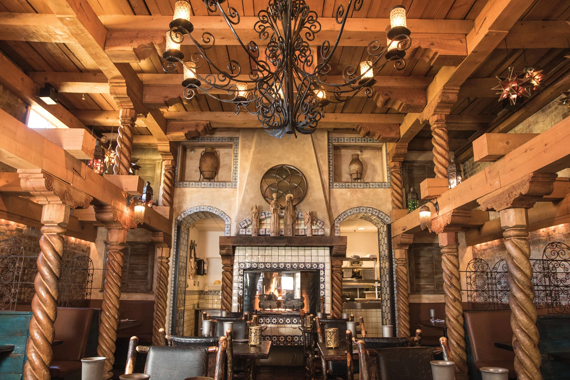 Elegant dining room with wooden decor and ambient lighting at Chimayo restaurant.
