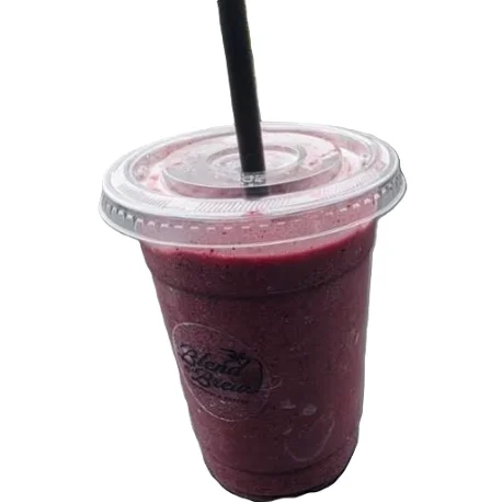 Colorful smoothie in a glass with fresh fruits and a straw