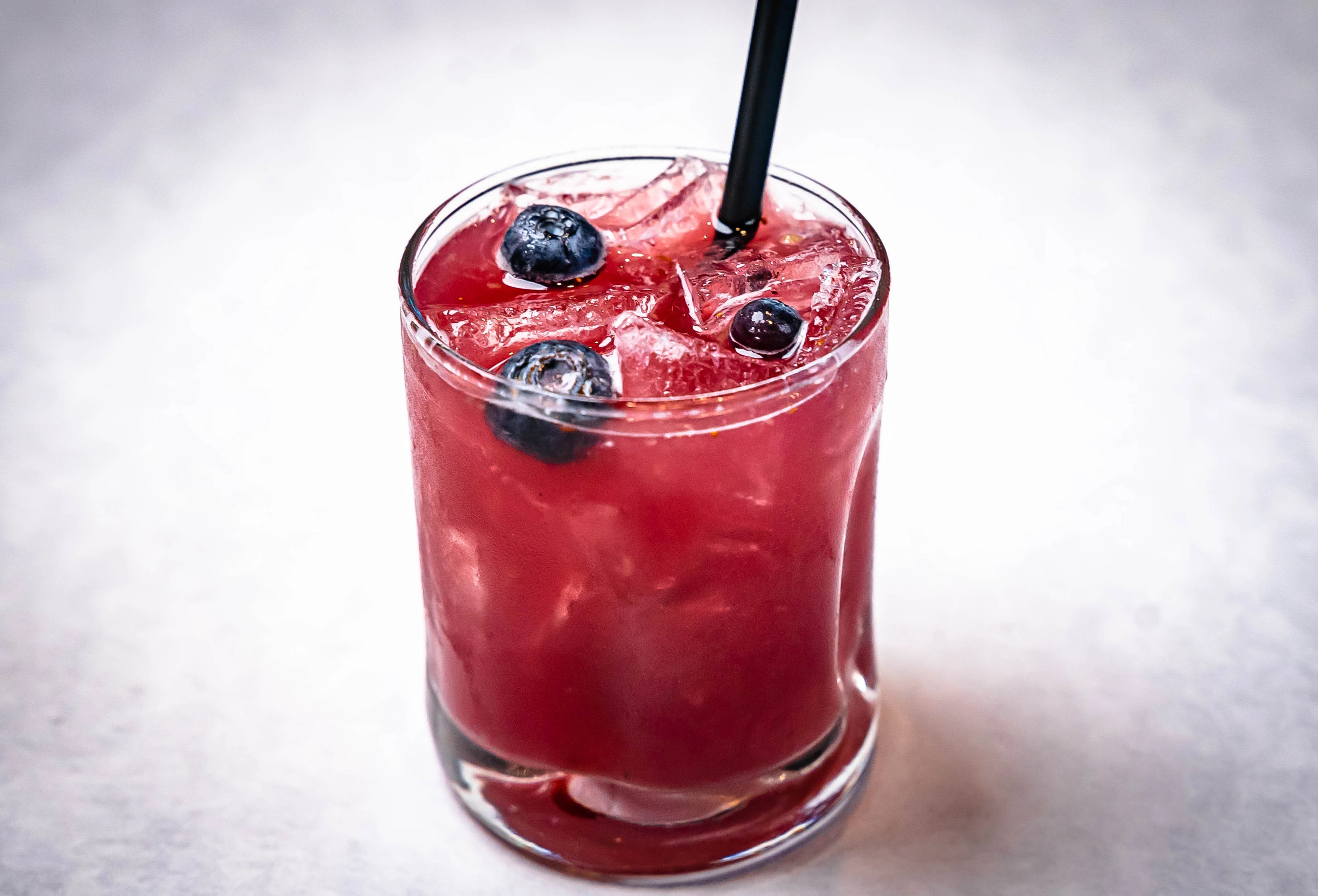 Refreshing berry cocktail with blueberries and ice