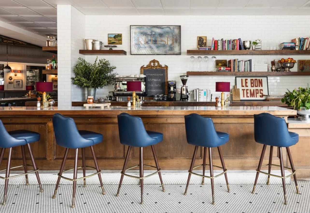 Stylish bar interior with blue stools and decorative shelves