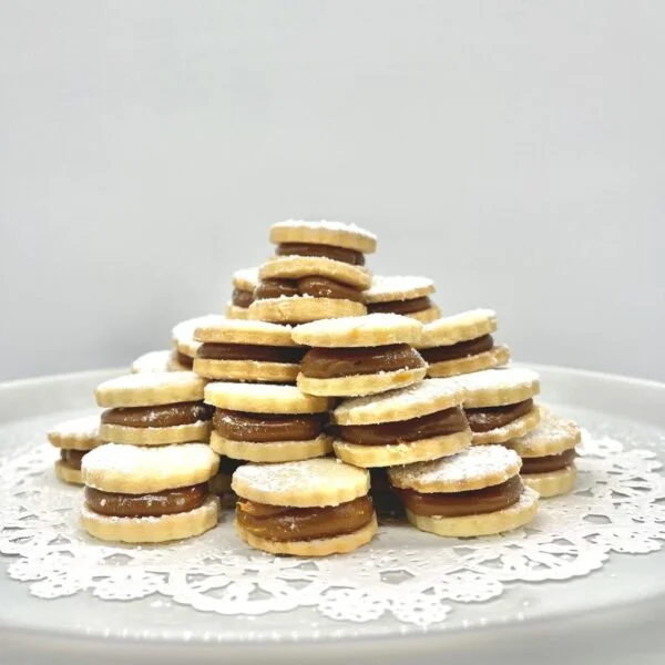 Delicious alfajores stacked on a decorative plate