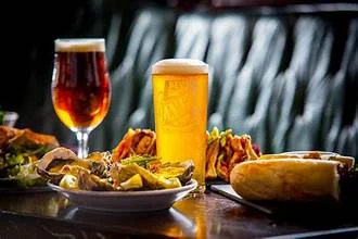 Craft beers with tacos and fresh salads on a rustic table