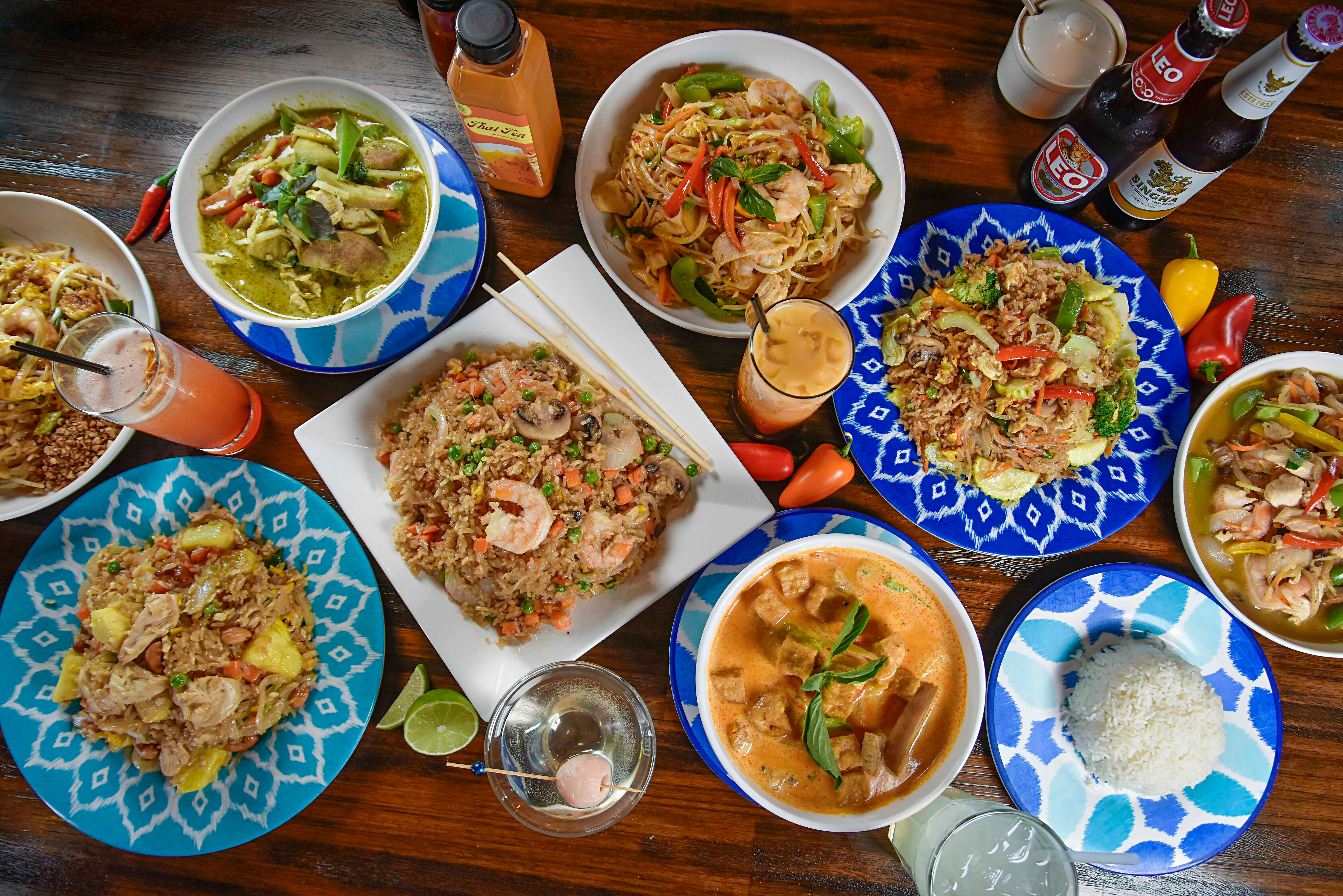 Assorted Thai dishes including green curry and fried rice