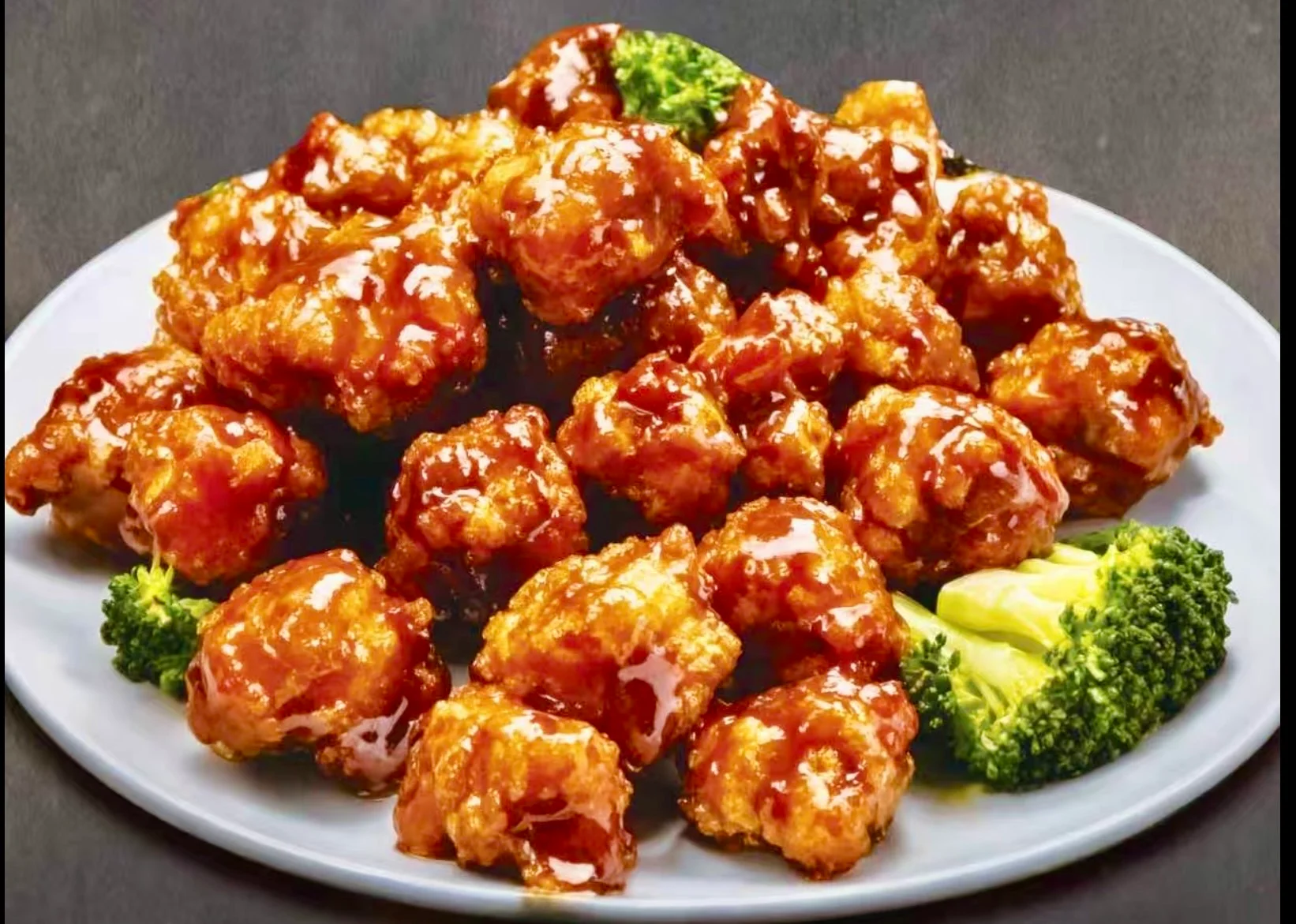 Crispy orange chicken with broccoli garnish
