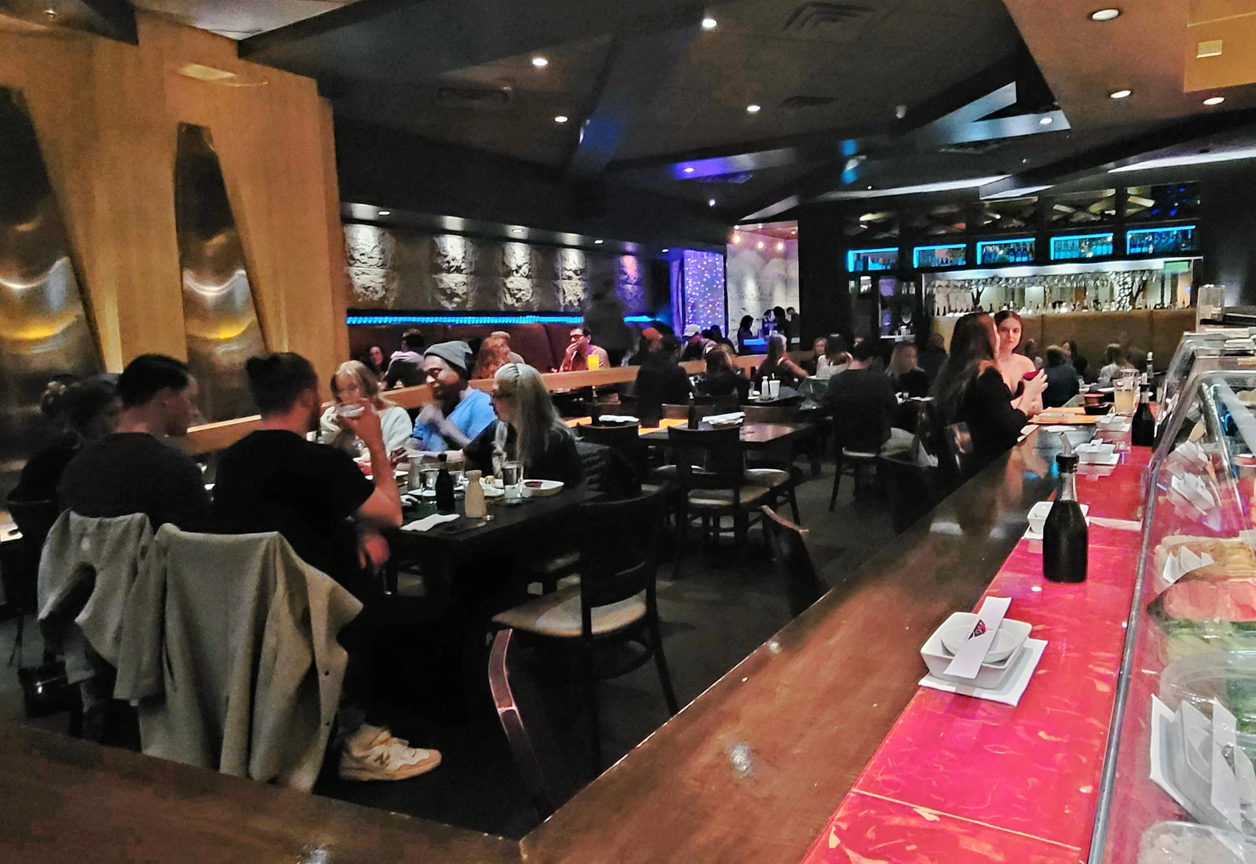 Cozy restaurant interior with vibrant lighting and lively atmosphere