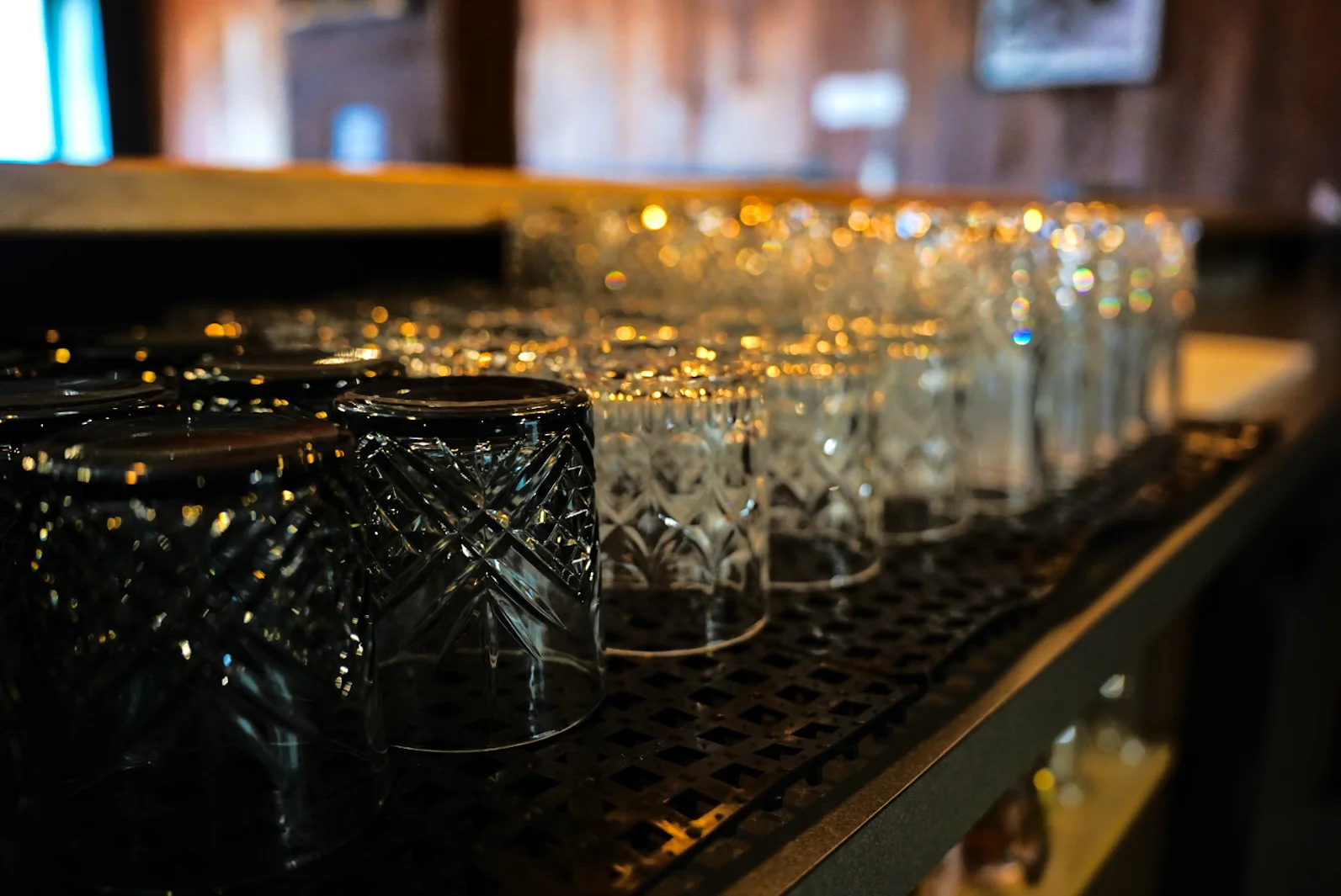 Row of elegant glassware on a bar counter
