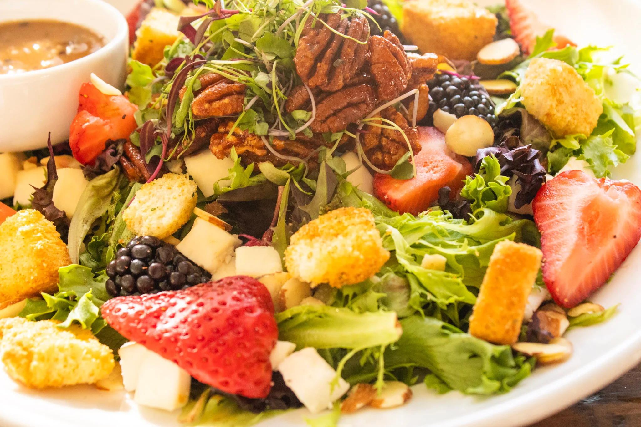 Colorful garden salad with pecans and berries
