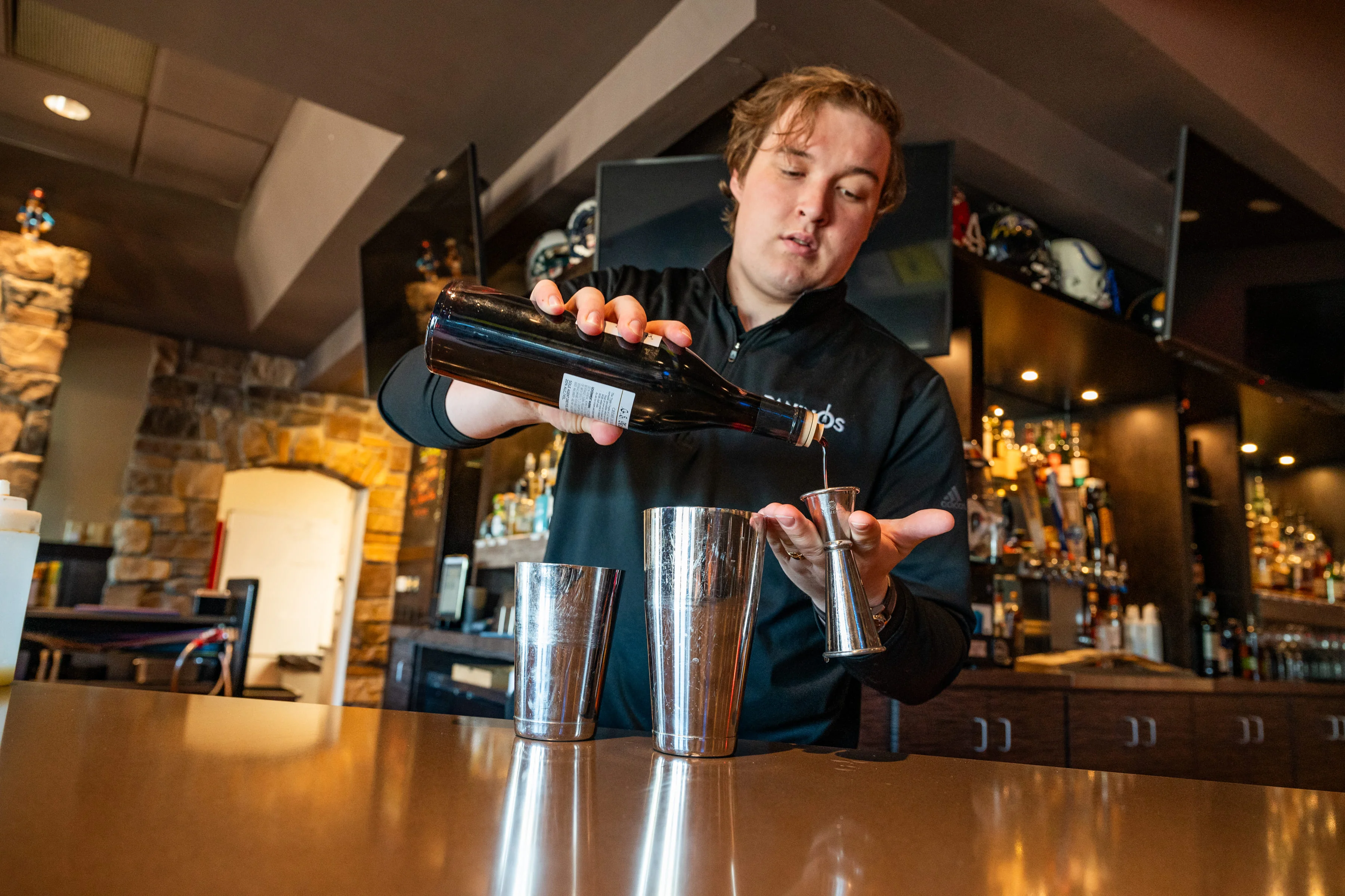 Bartender pouring a cocktail at a stylish bar