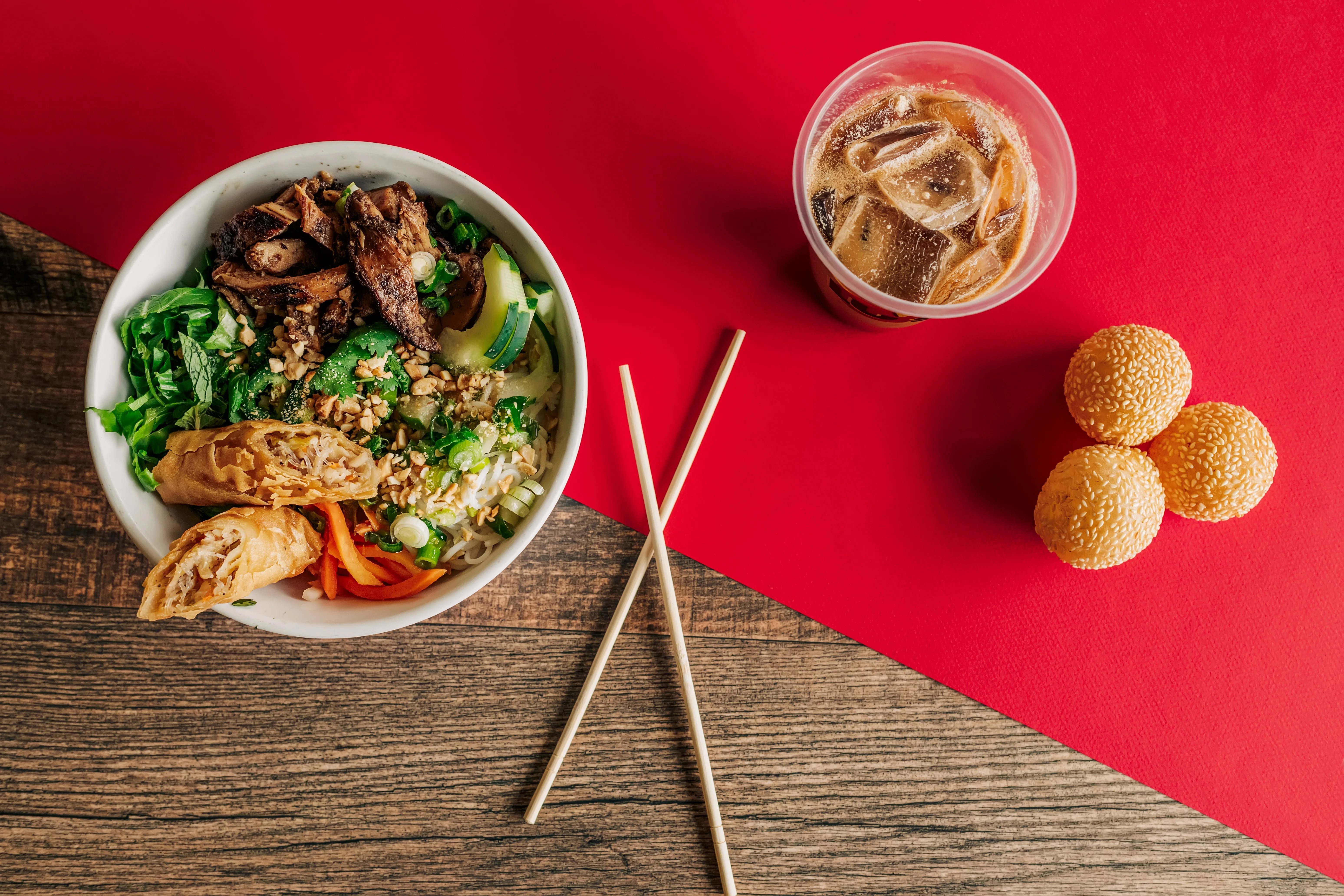 Vietnamese bun bowl with grilled chicken and spring rolls