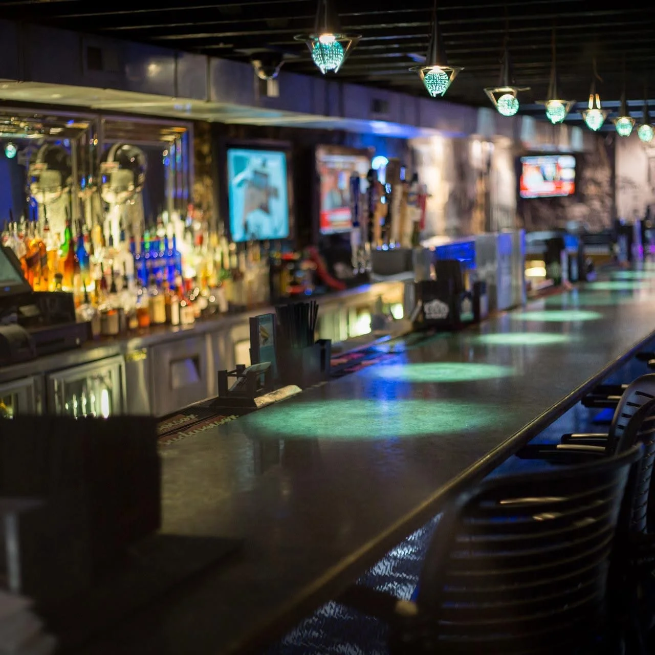 Interior view of a cozy restaurant with wooden decor and warm lighting.