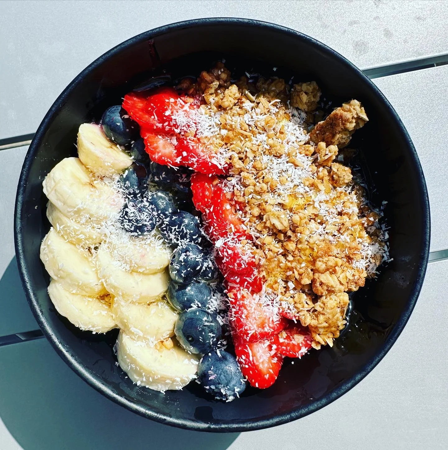 Colorful acai bowl topped with fresh fruits and granola