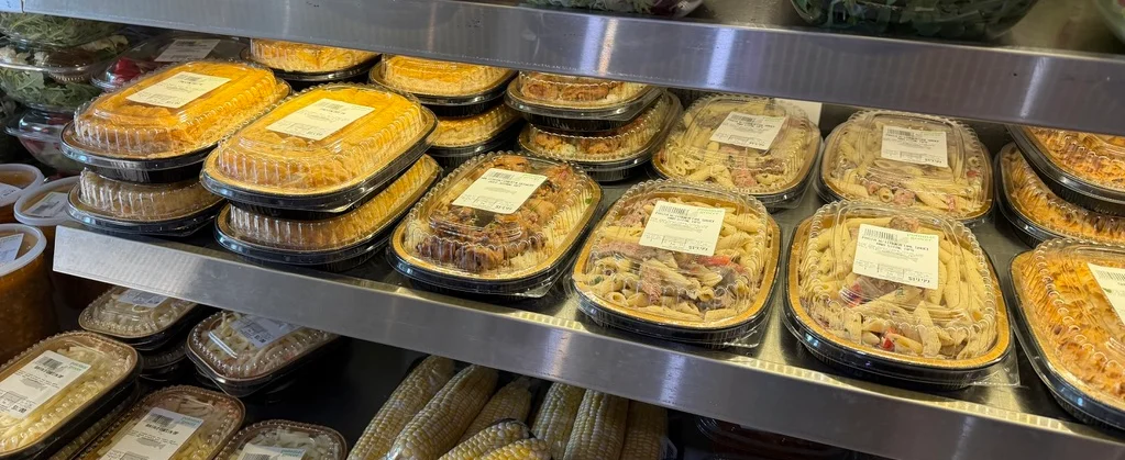 Close-up of prepared food in labeled plastic takeaway containers