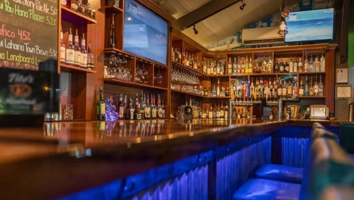 Cozy bar interior with a well-stocked liquor shelf