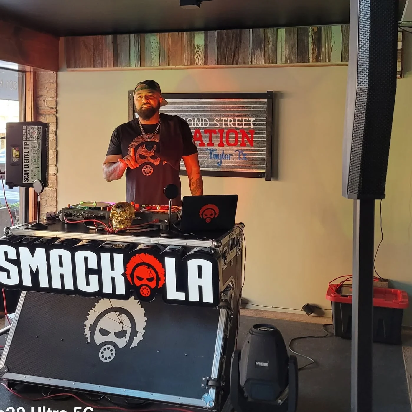 DJ performing at a lively restaurant event with a vibrant atmosphere