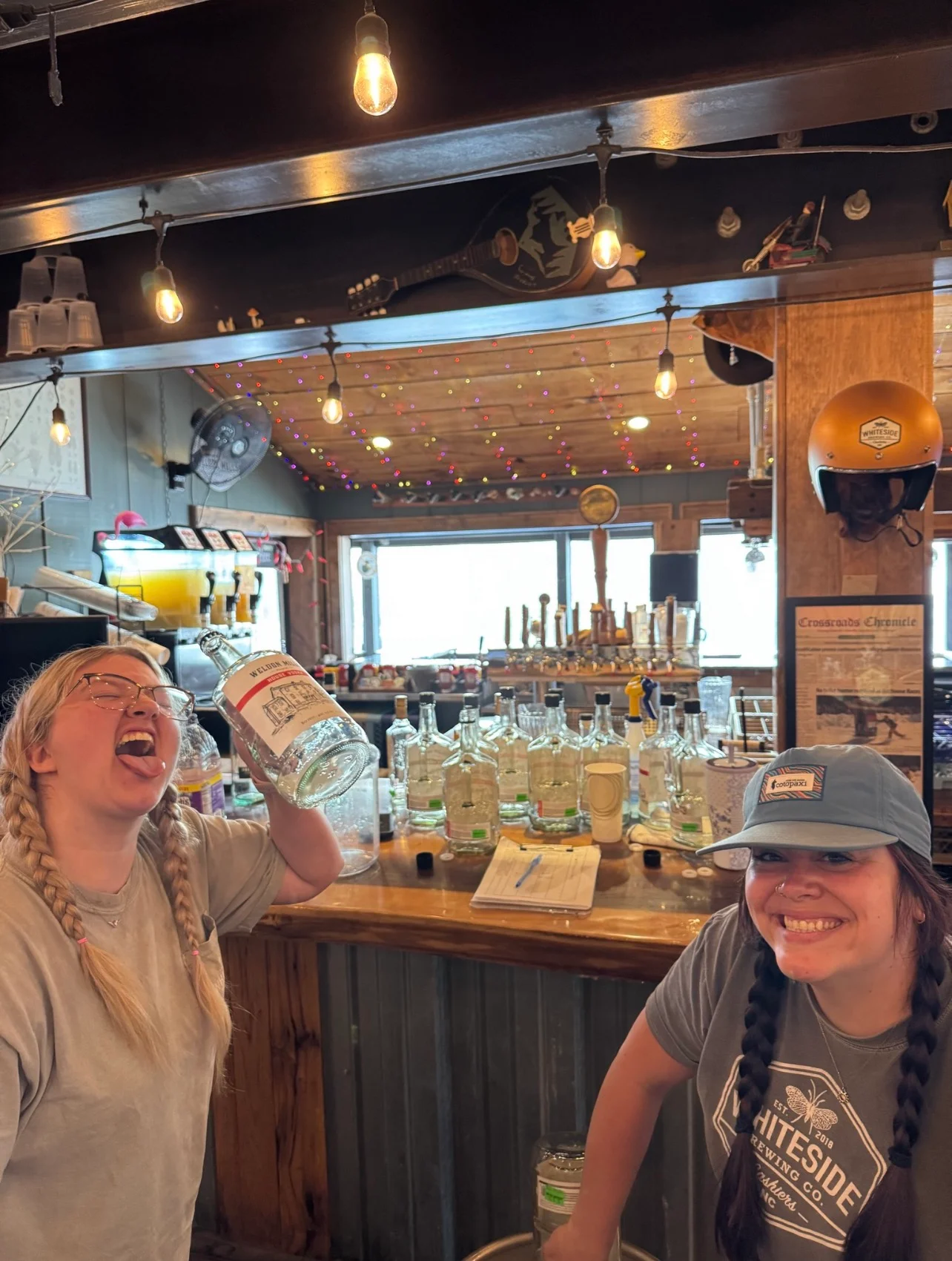 Bartenders enjoying drinks at a lively bar counter