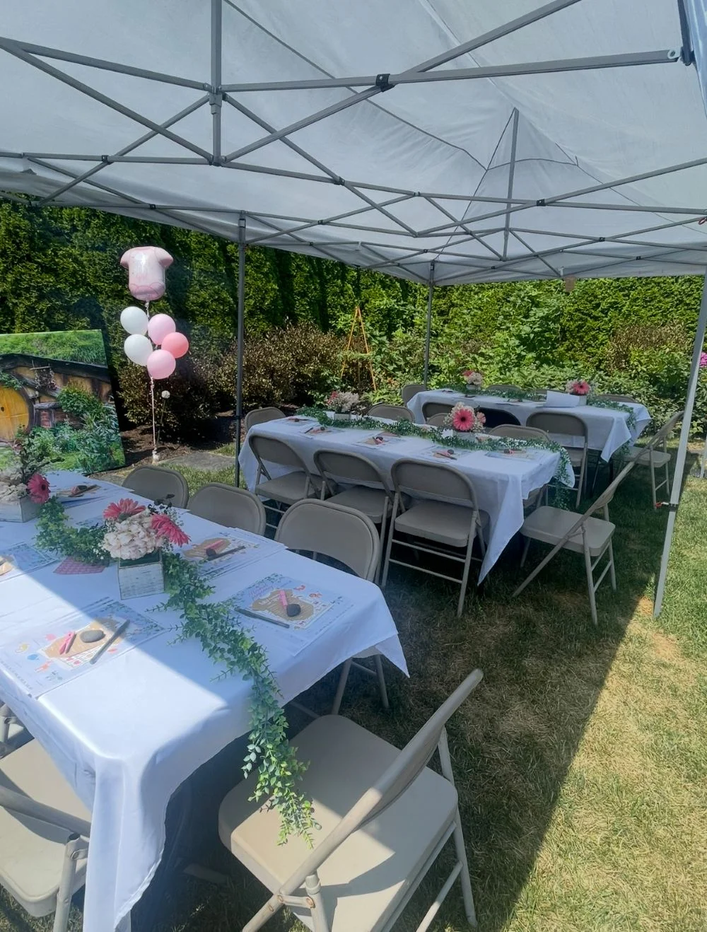 Outdoor dining setup with decorated tables and balloons
