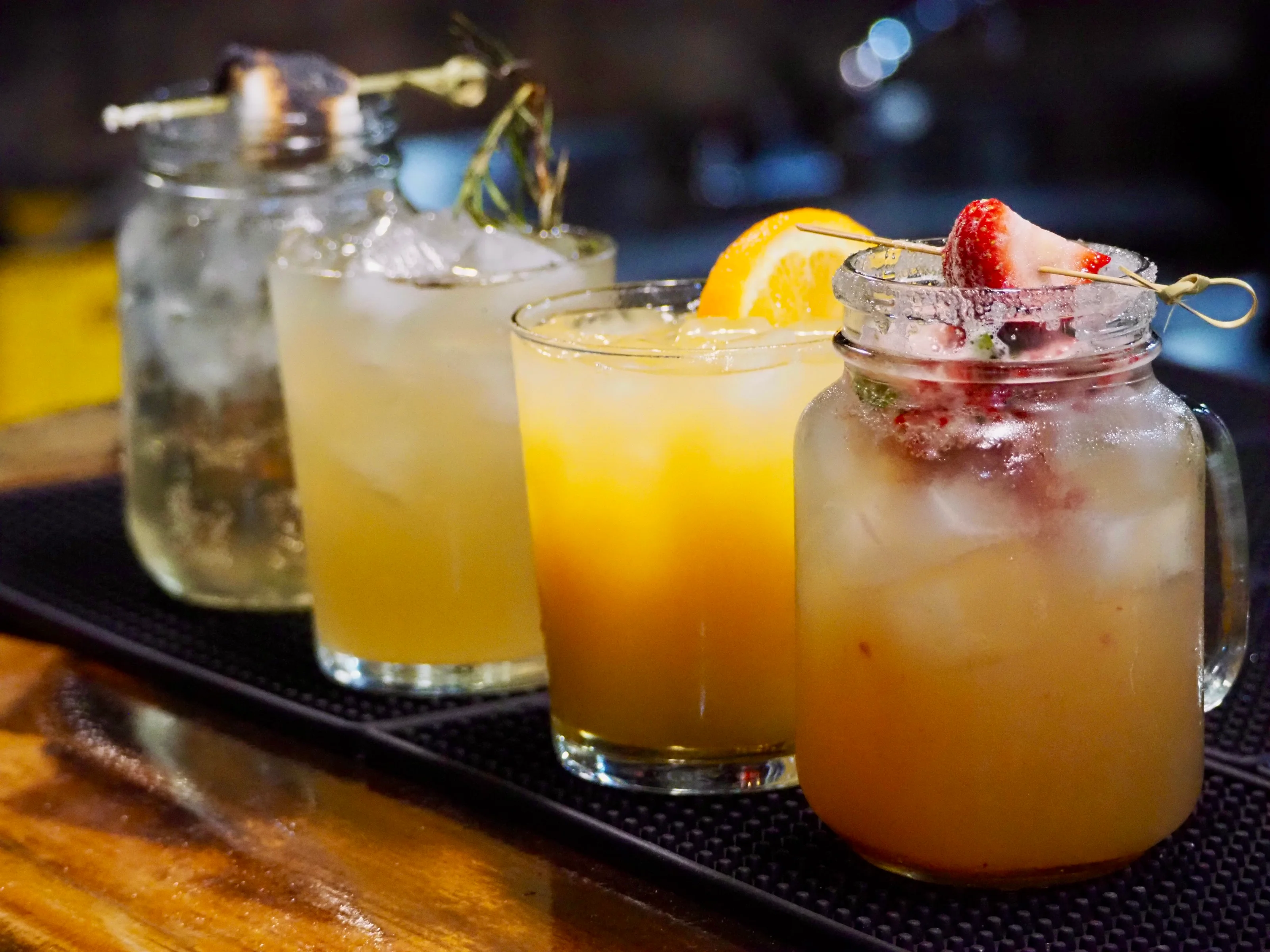 Colorful cocktails served in mason jars at a trendy bar