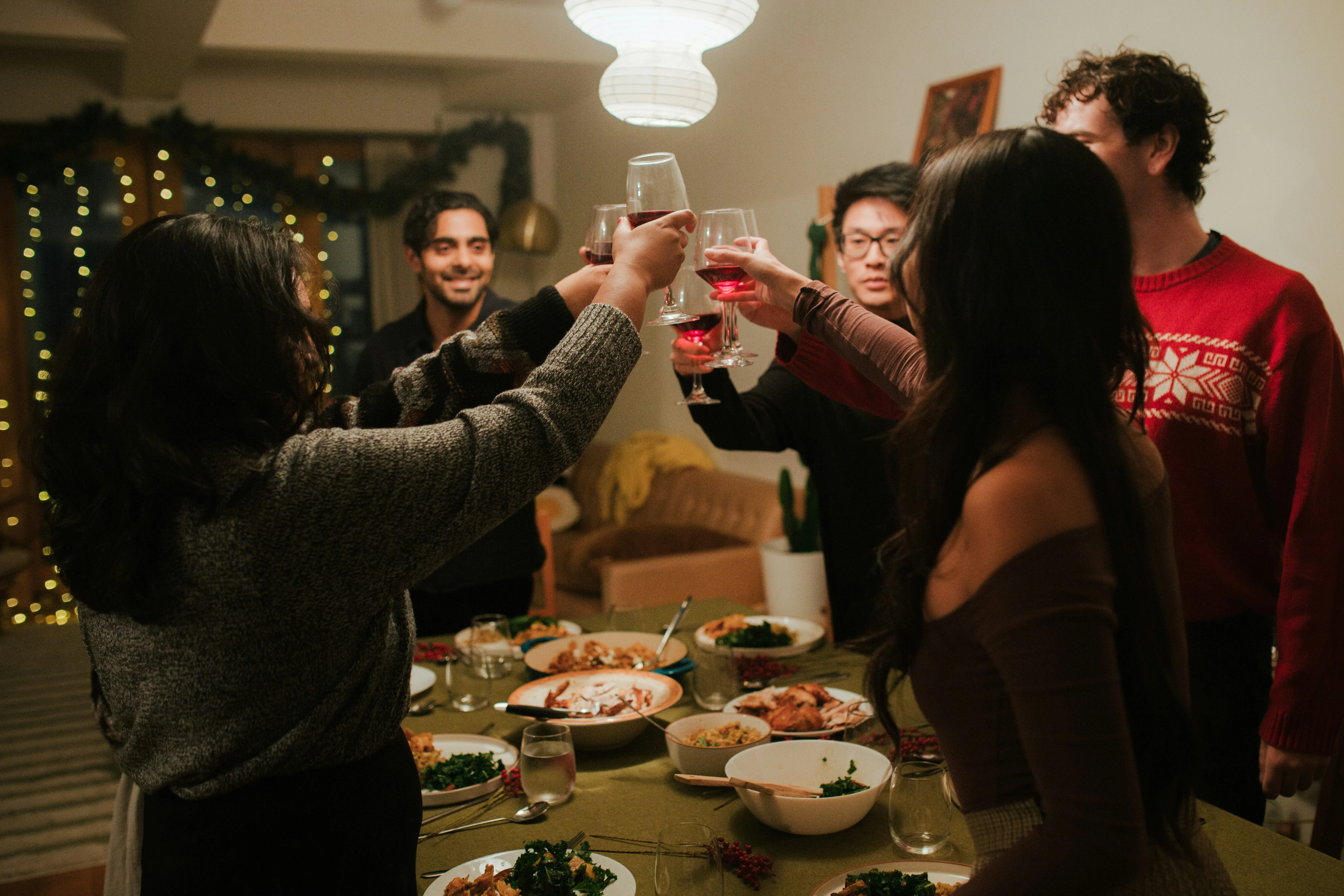 Blurred festive restaurant scene with plated roasted chicken and candles