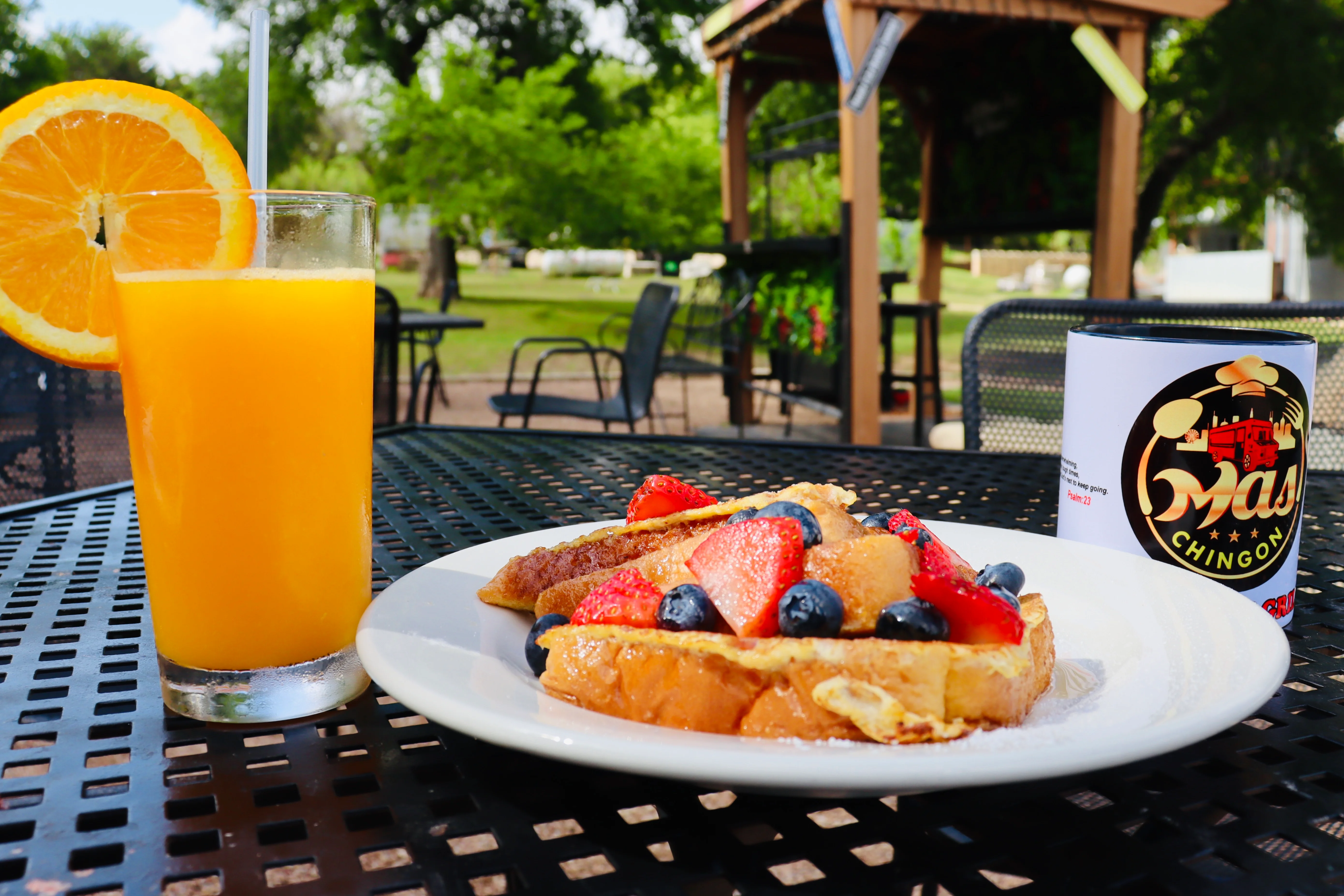French toast topped with fresh berries and orange juice