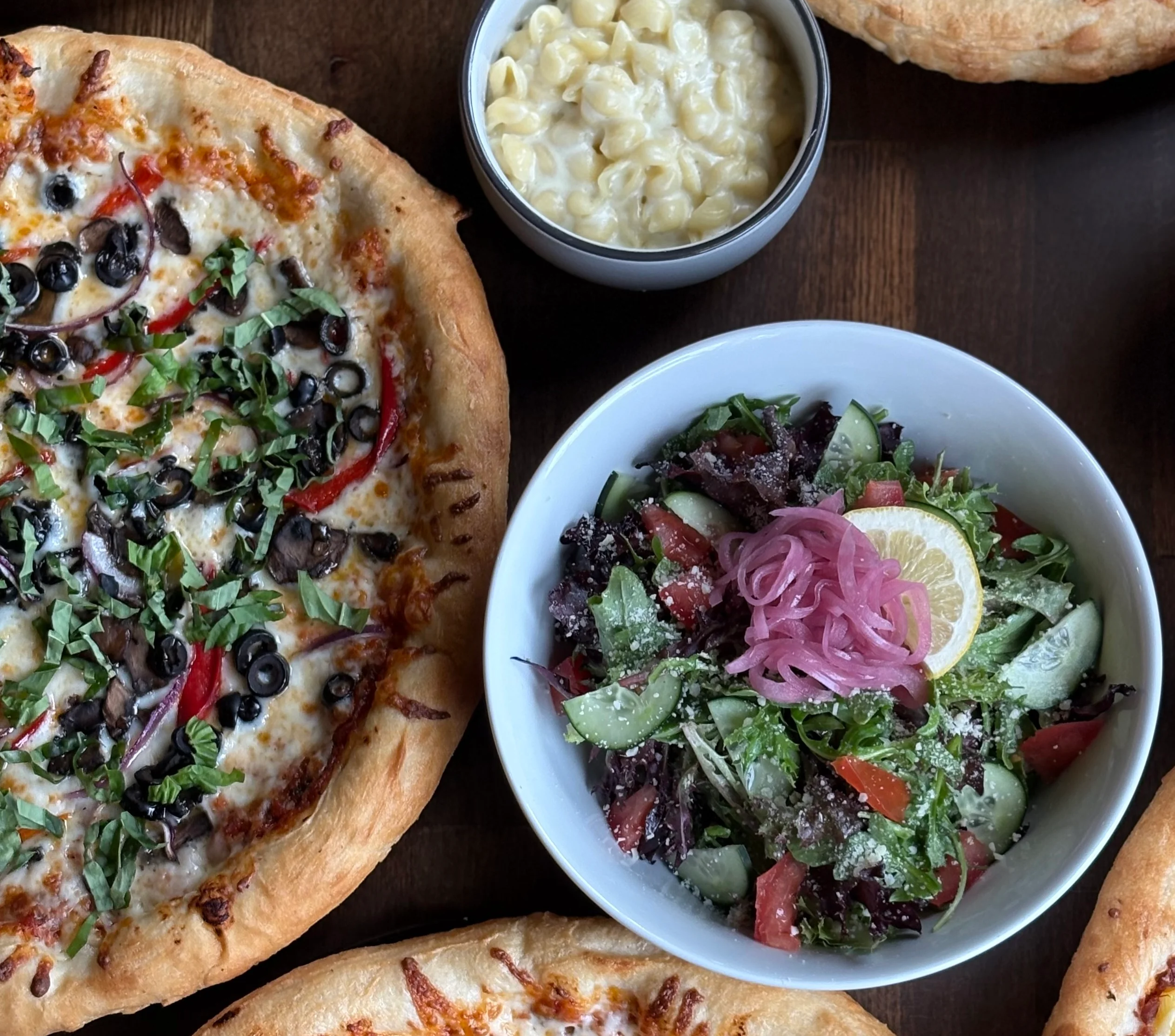 Vegetarian pizza with fresh toppings and a side salad