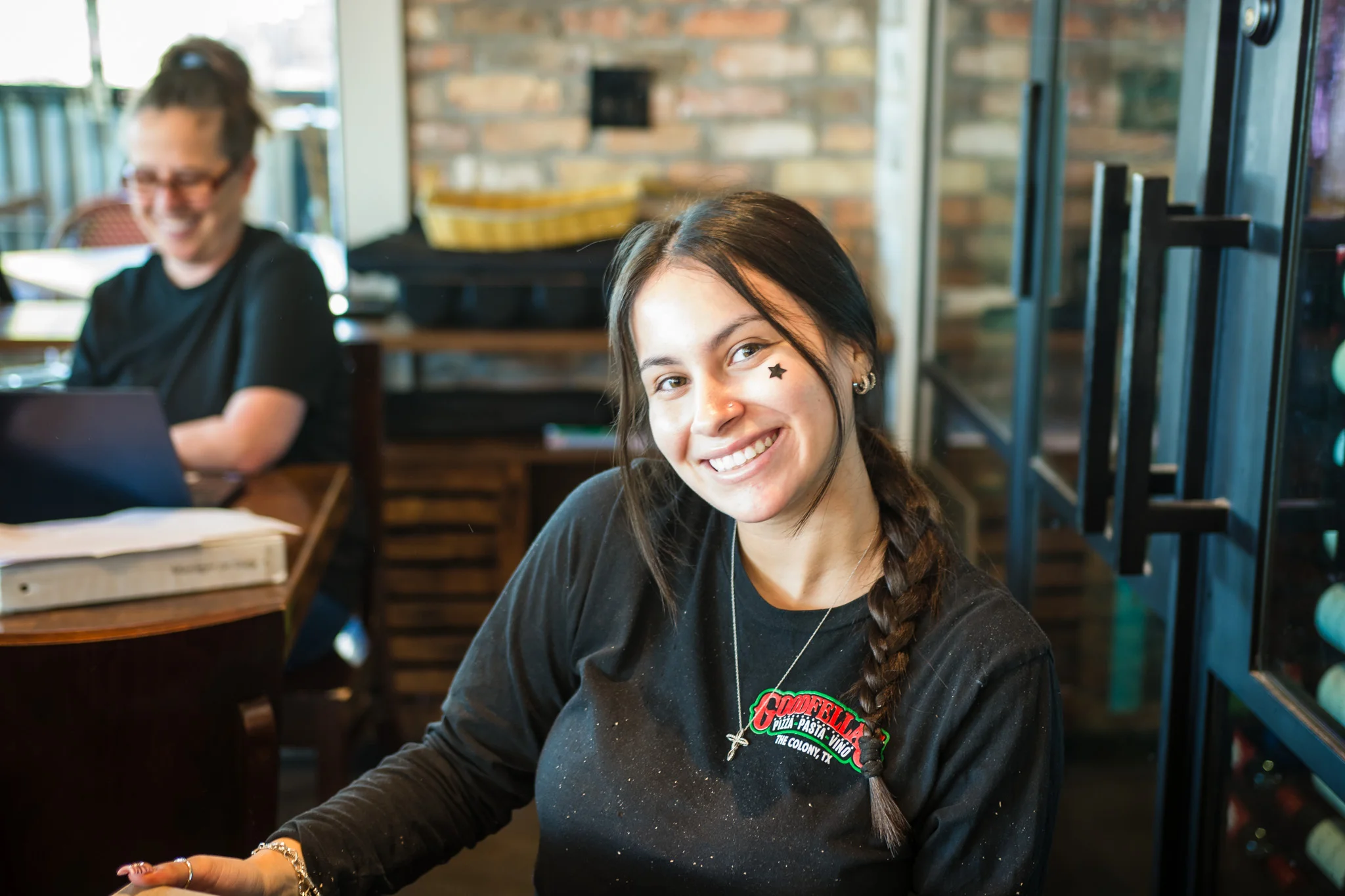 Smiling restaurant staff member in a cozy dining area