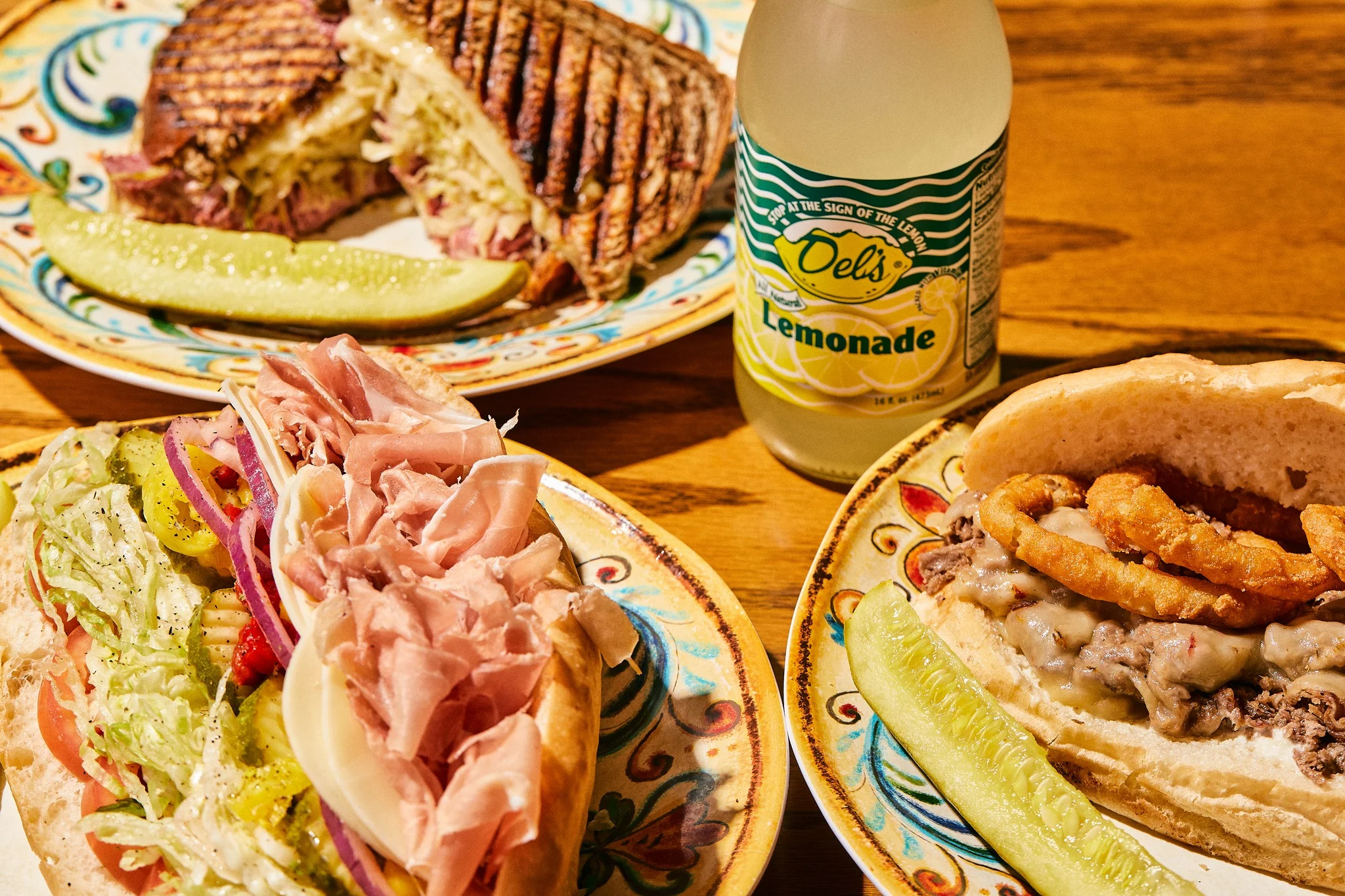 Italian deli sandwiches with lemonade and pickles
