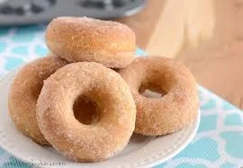 Freshly made cinnamon sugar donuts on a plate