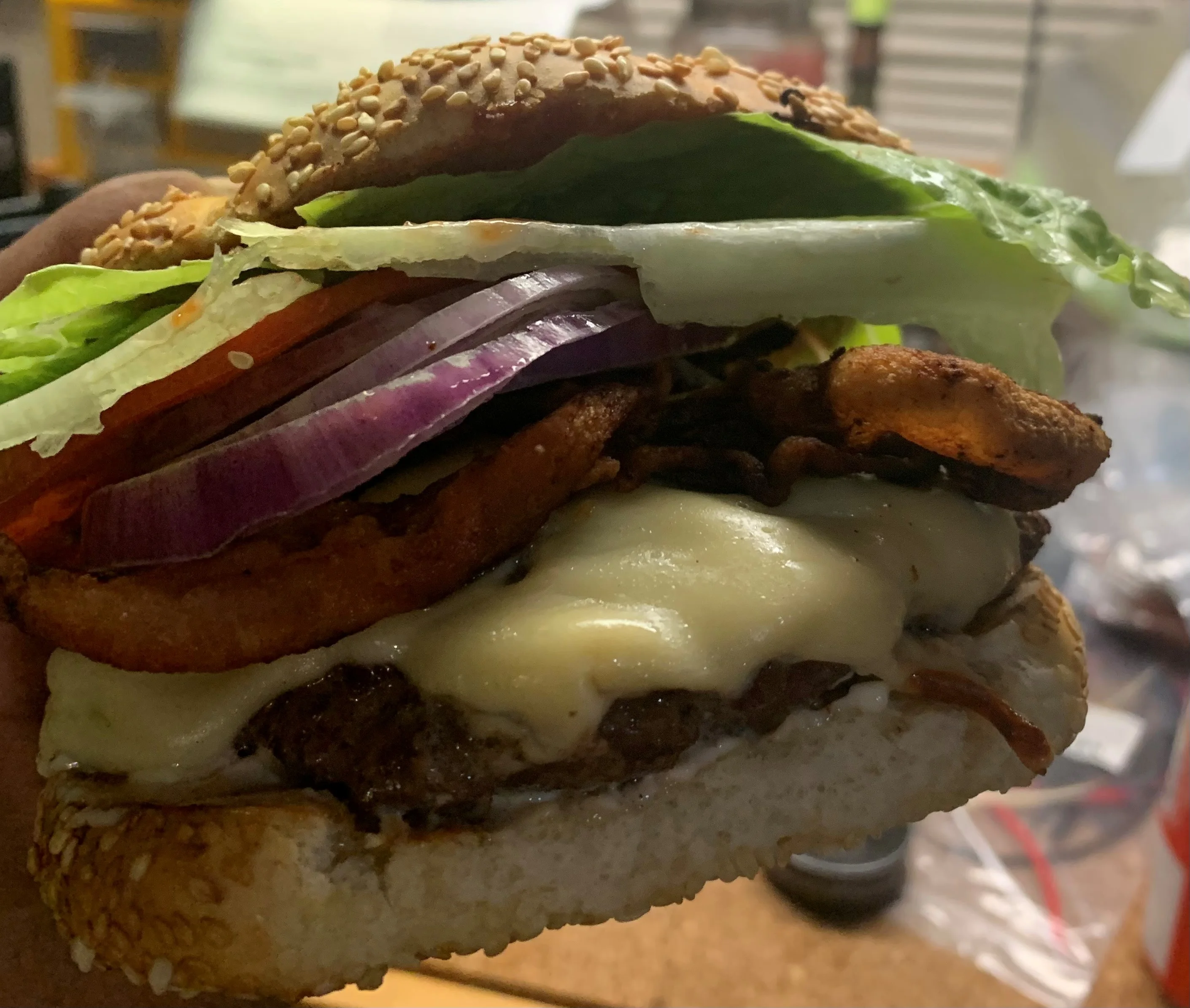 Juicy cheeseburger with crispy toppings and sesame bun