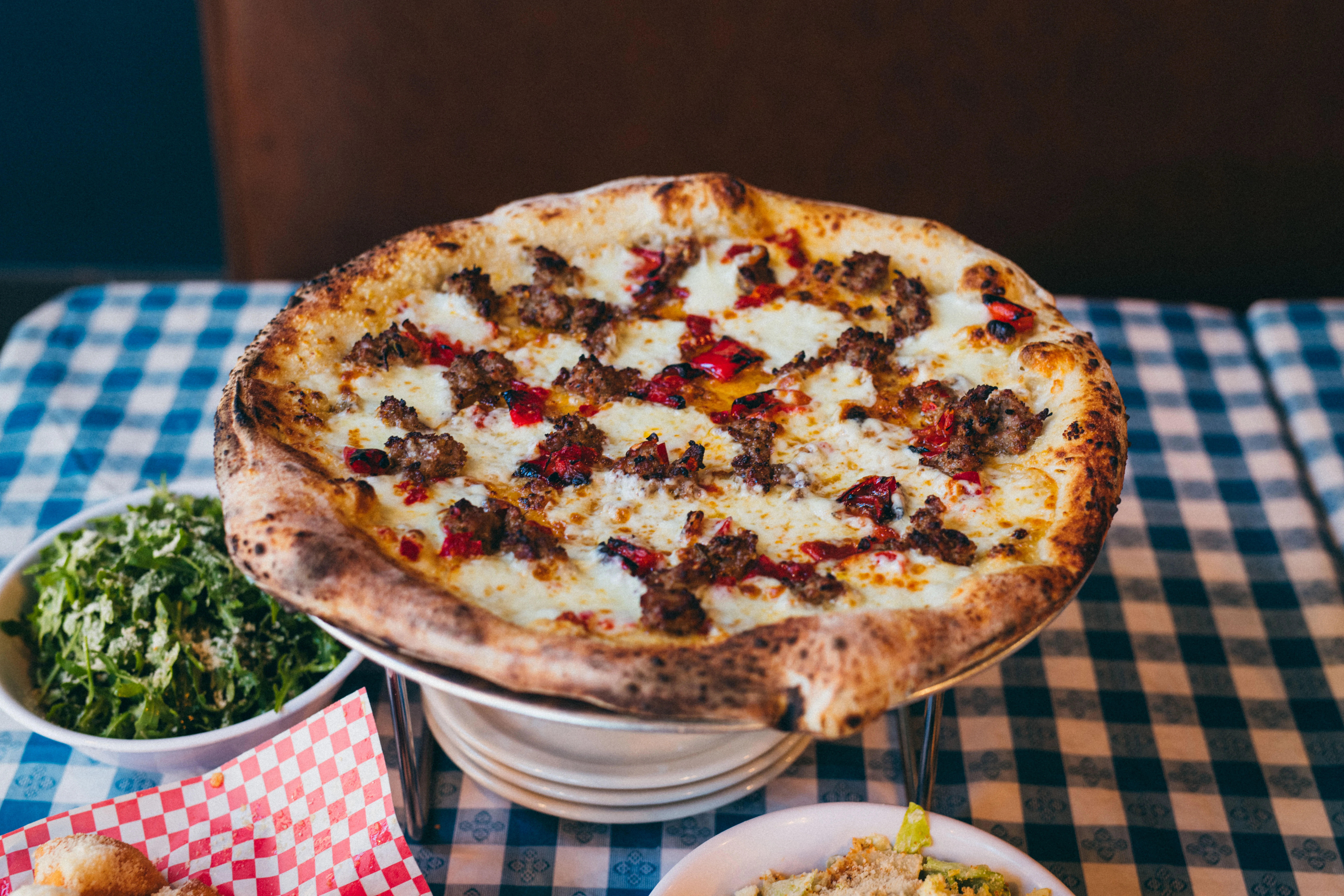 Sicilian-style pizza topped with sausage and roasted peppers