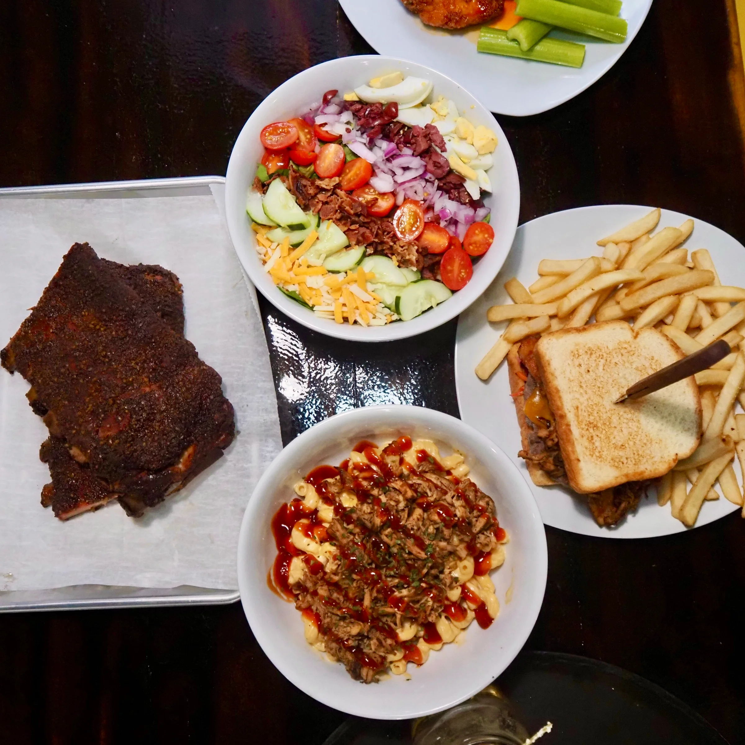 Smoked barbecue ribs with sides in a vibrant restaurant setting