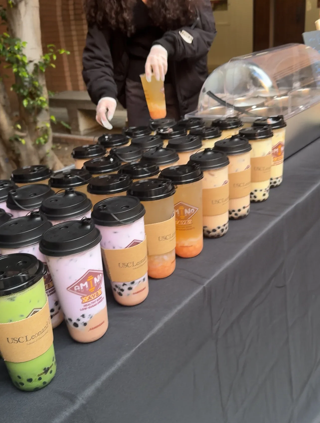 Colorful bubble tea drinks on display at an event