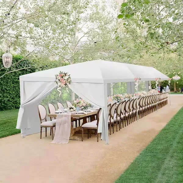 Elegant outdoor dining setup under a white tent