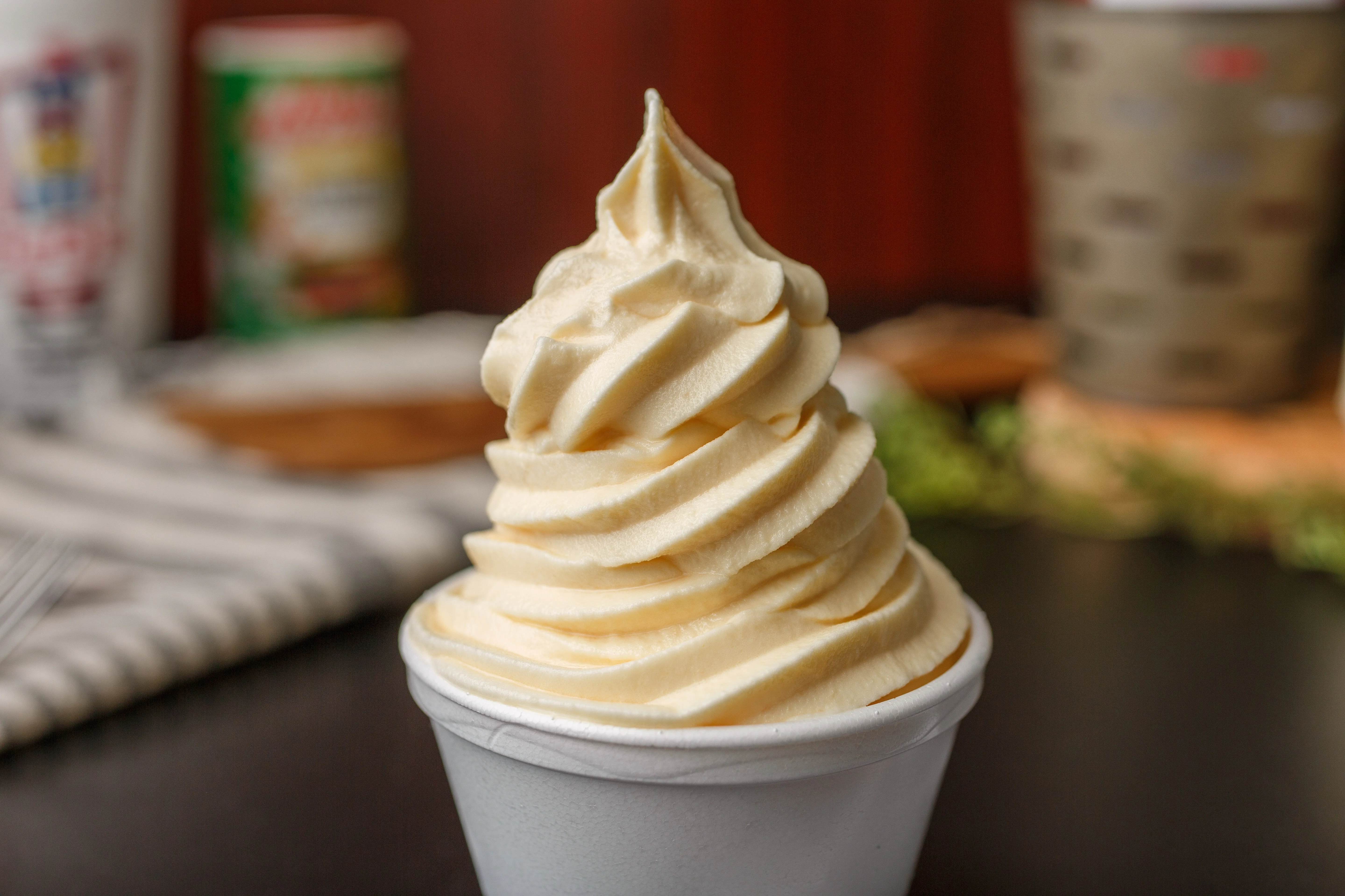 Delicious soft serve ice cream in a cup with a creamy swirl.