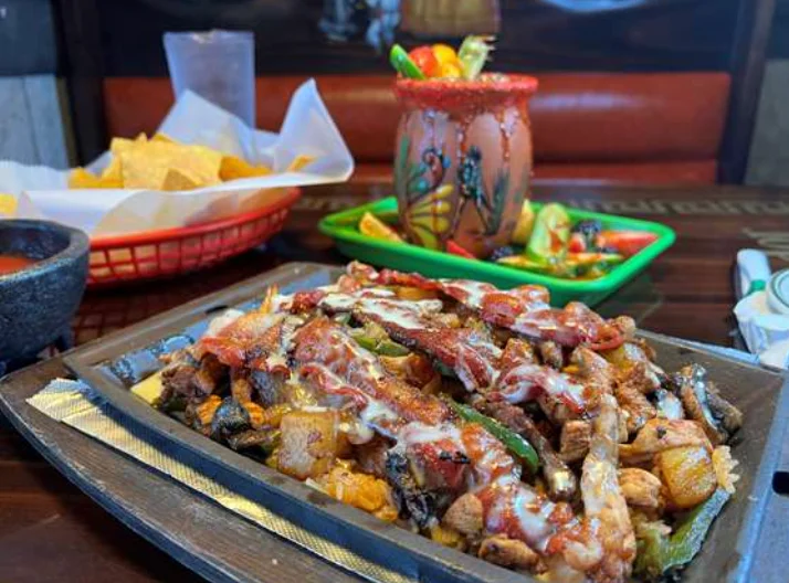 Sizzling fajitas served on a hot skillet