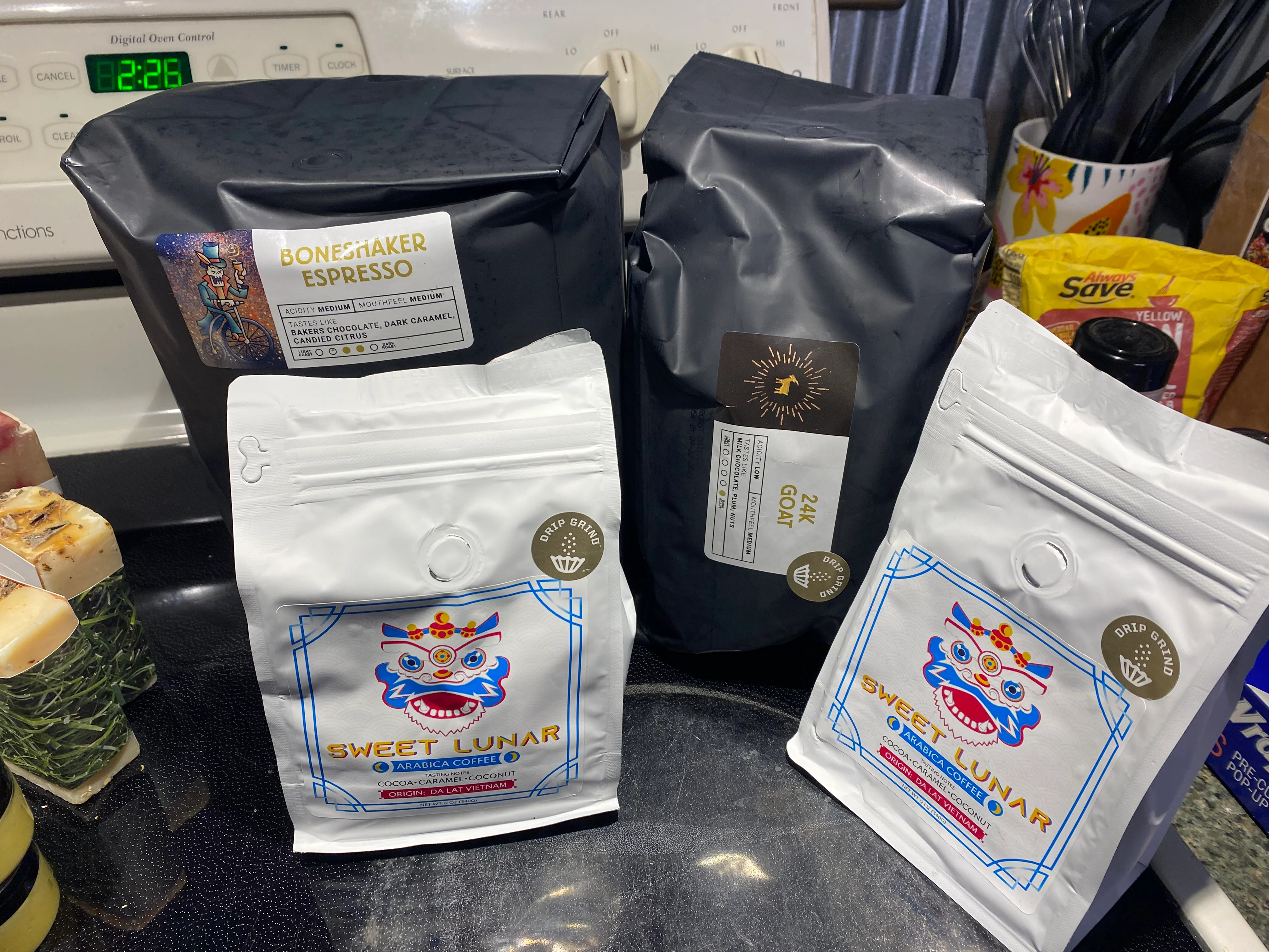 Variety of specialty coffee bags on a kitchen counter