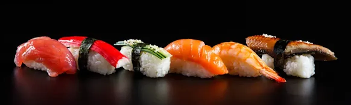Assorted sushi nigiri on a black background