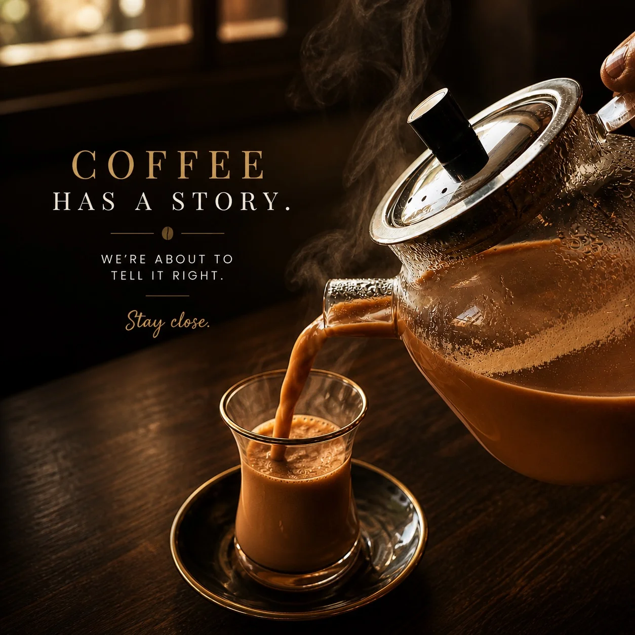 Pouring coffee from a pot into a glass cup with steam rising.