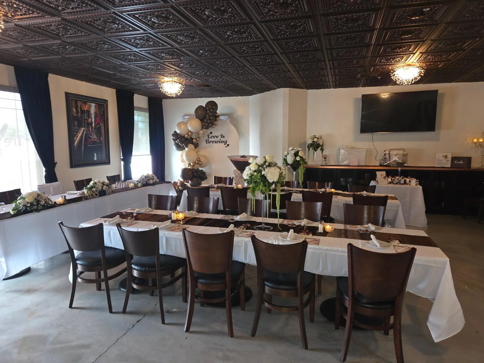 Elegant restaurant dining room with ornate ceiling and floral event tables