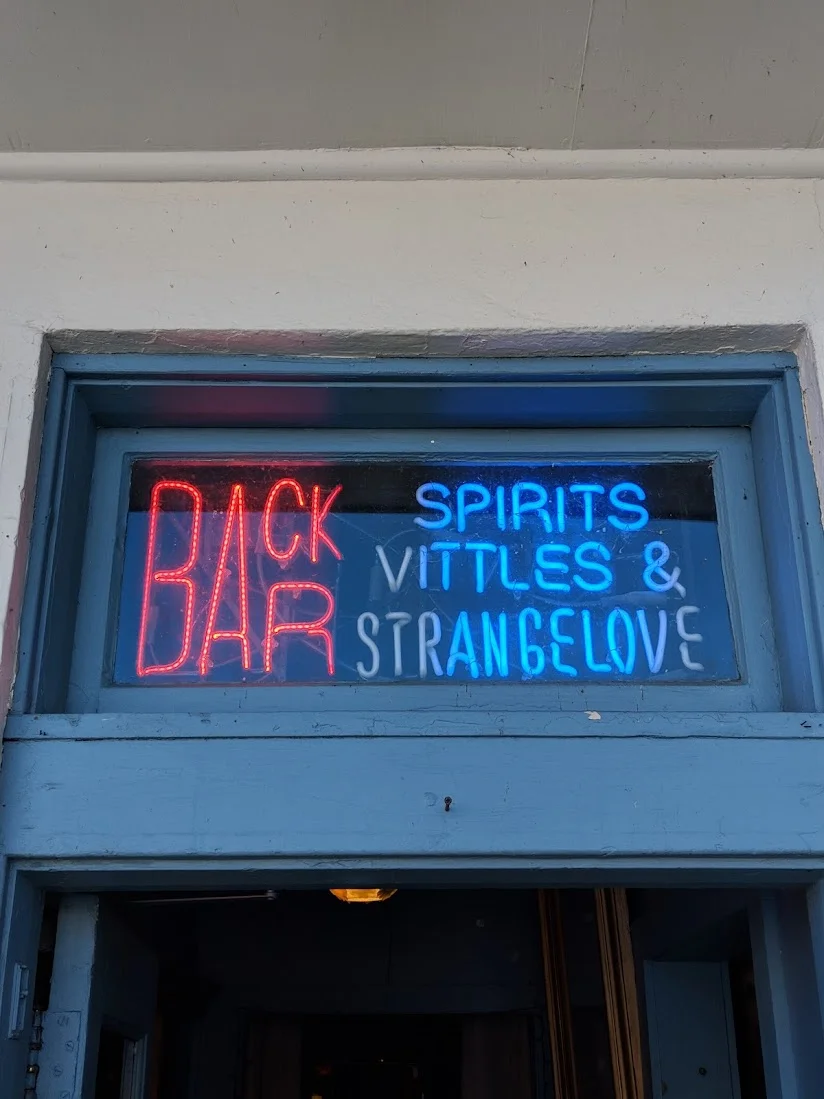 Neon sign for Back Bar featuring spirits and vittles