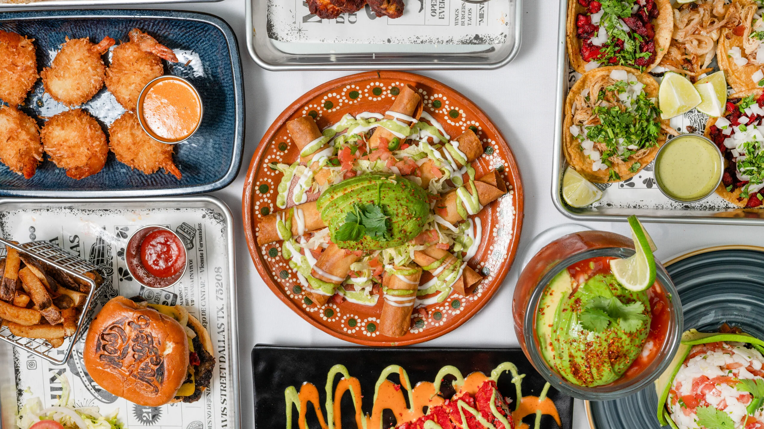 Colorful Mexican feast with tacos, flautas, and shrimp fritters