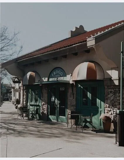 Charming coffee shop exterior with colorful awnings