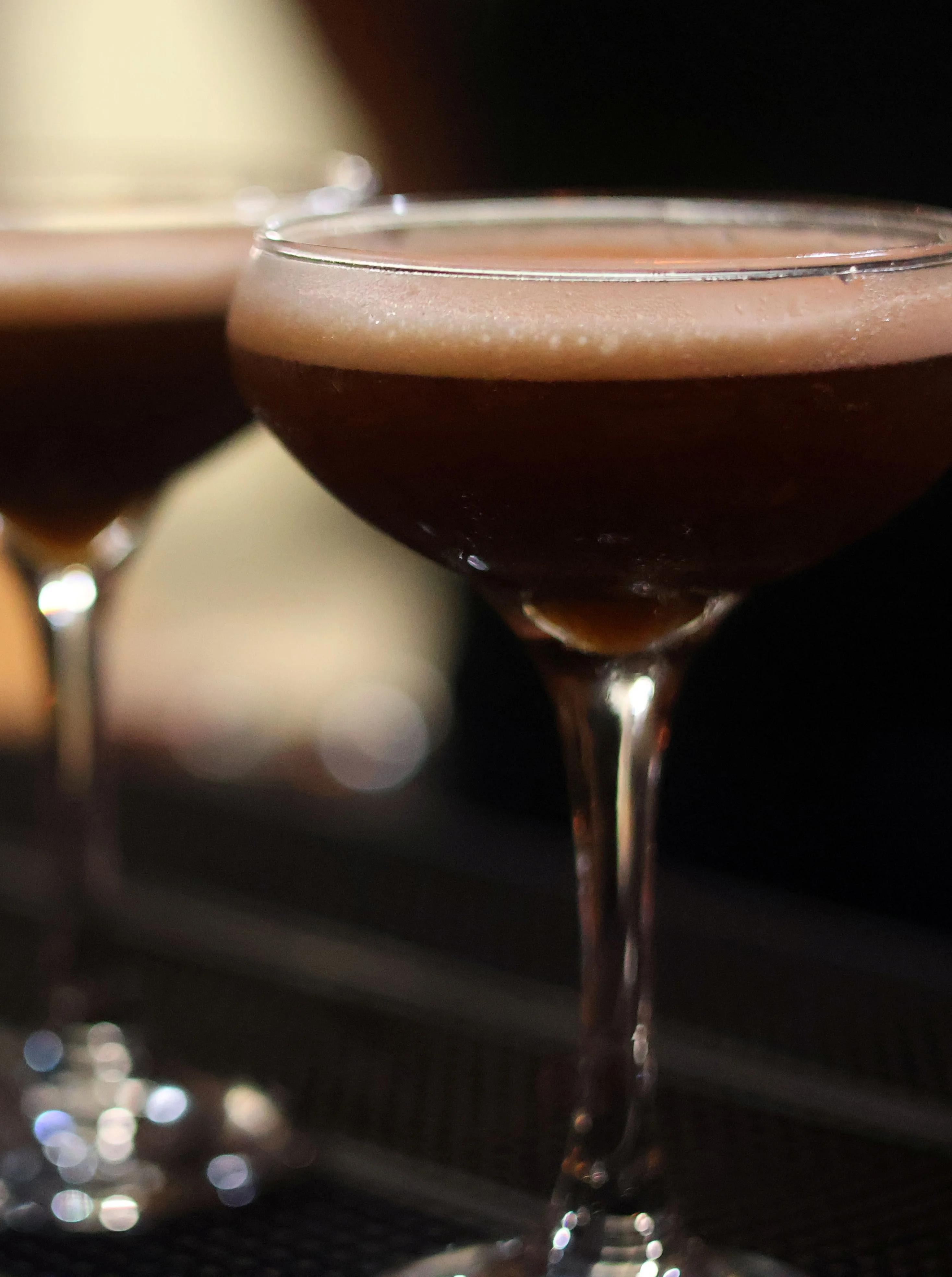 Crafting a classic cocktail with orange garnish
