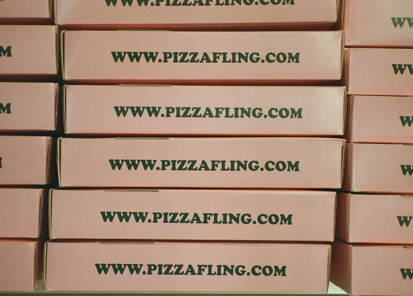 Stack of pizza boxes with branding