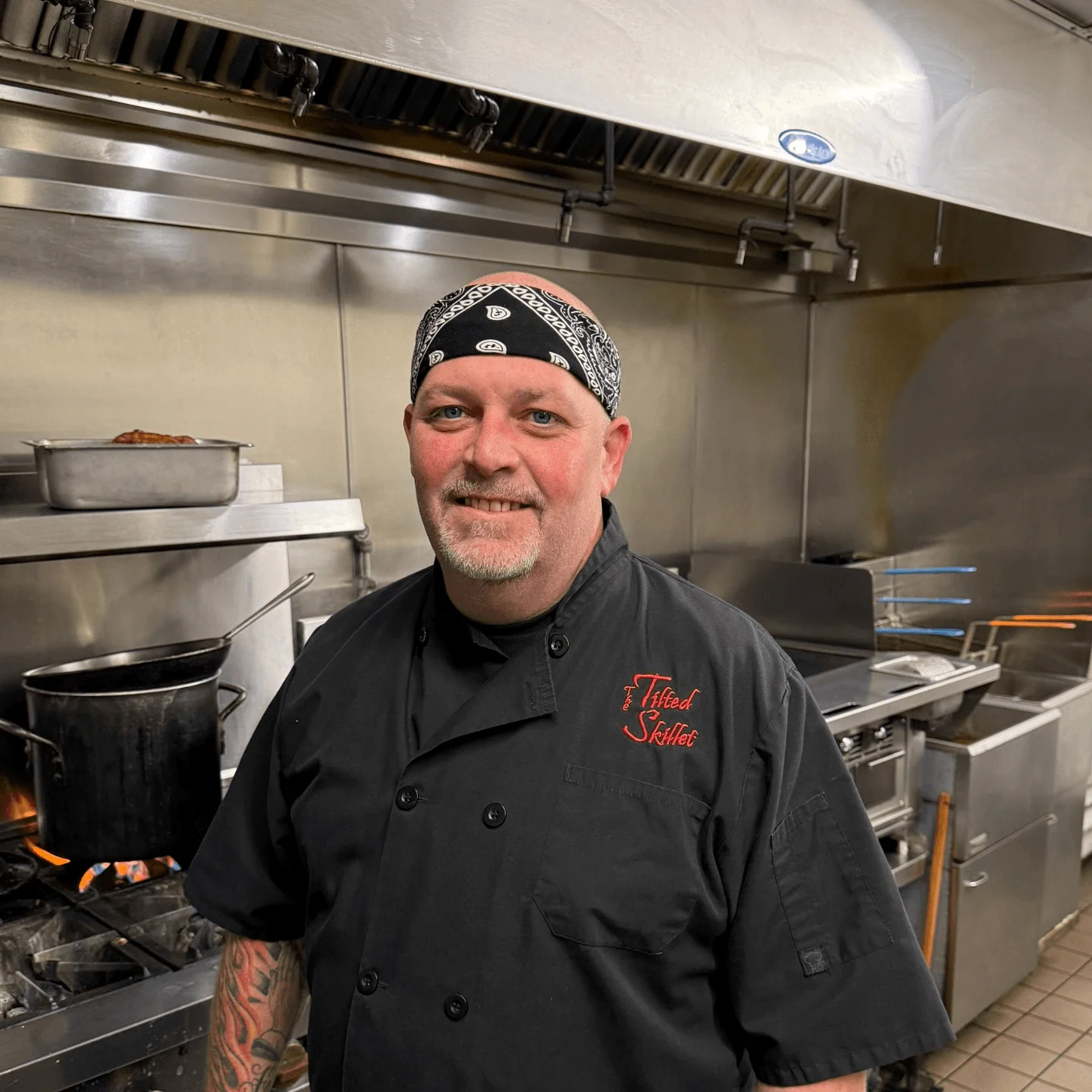 Chef in a professional kitchen with cooking equipment