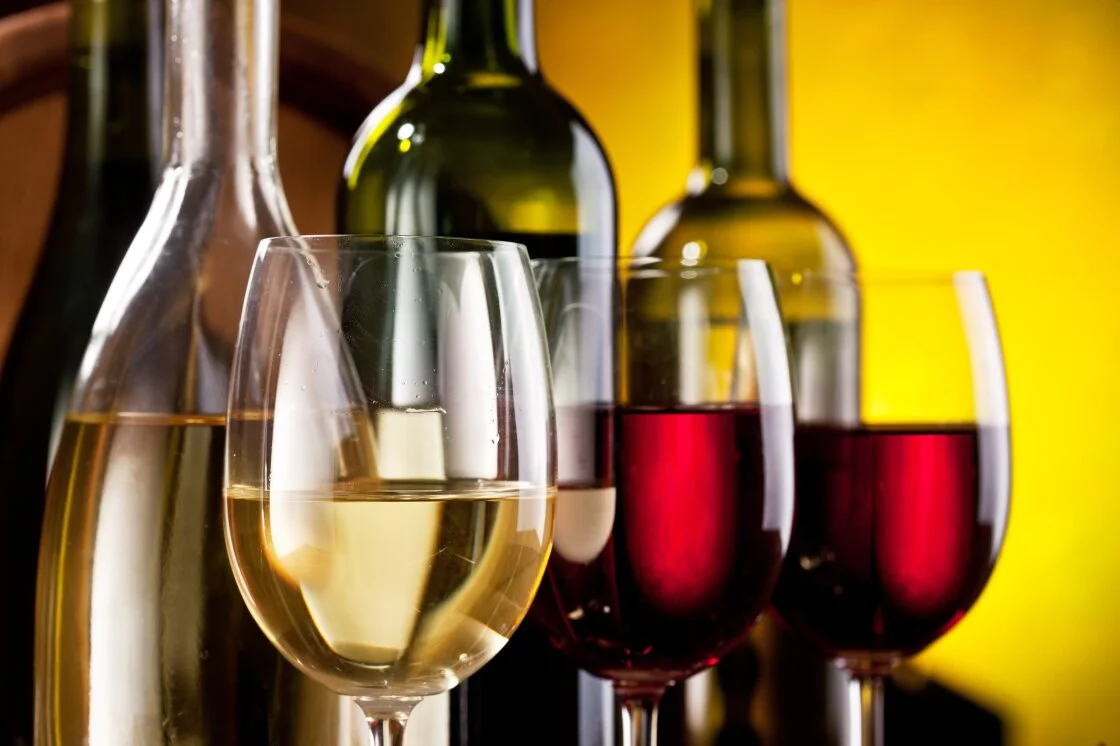 Selection of wine bottles and glasses with white and red wine