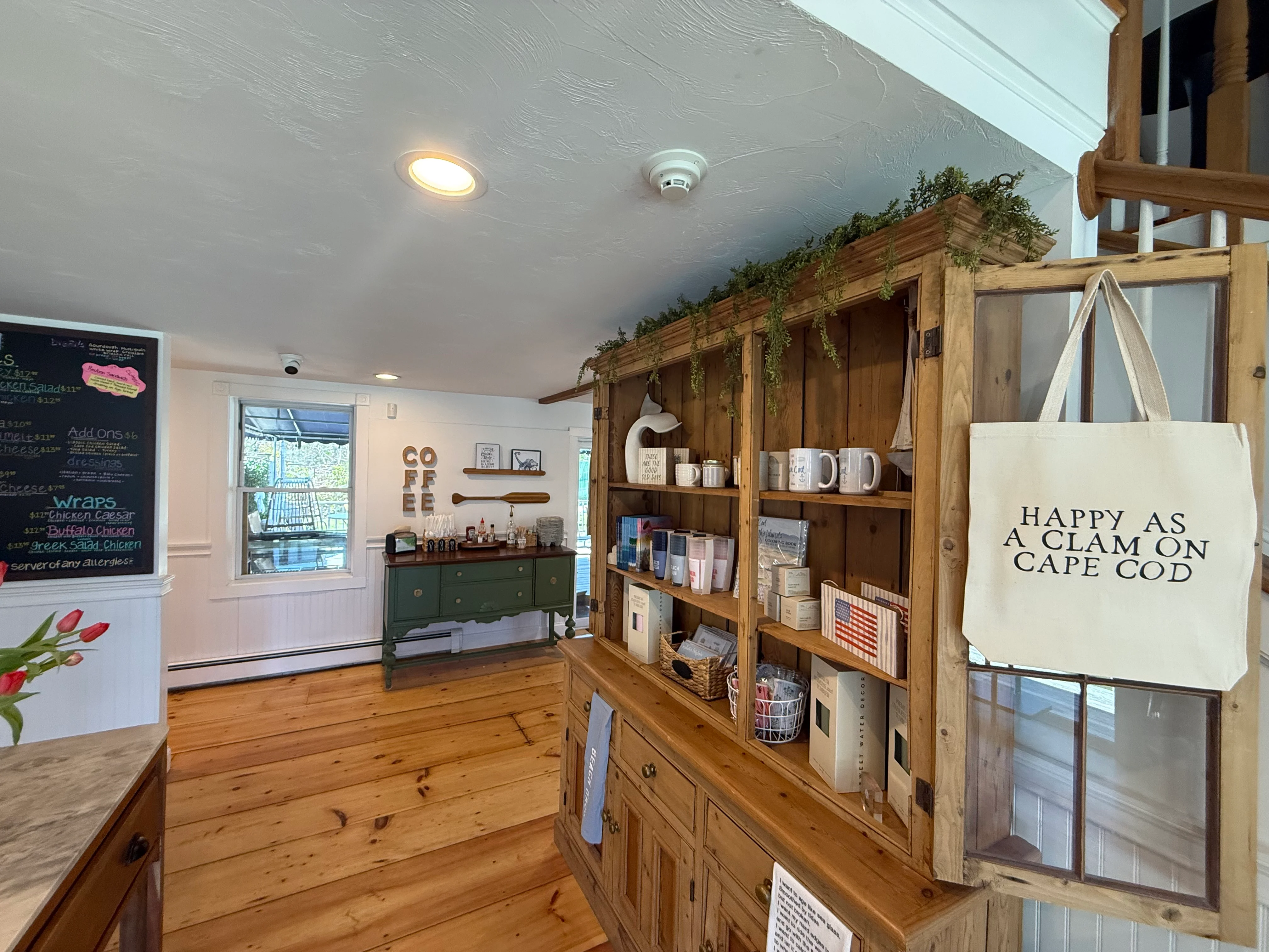 Cozy café interior with wooden shelves and a menu board.