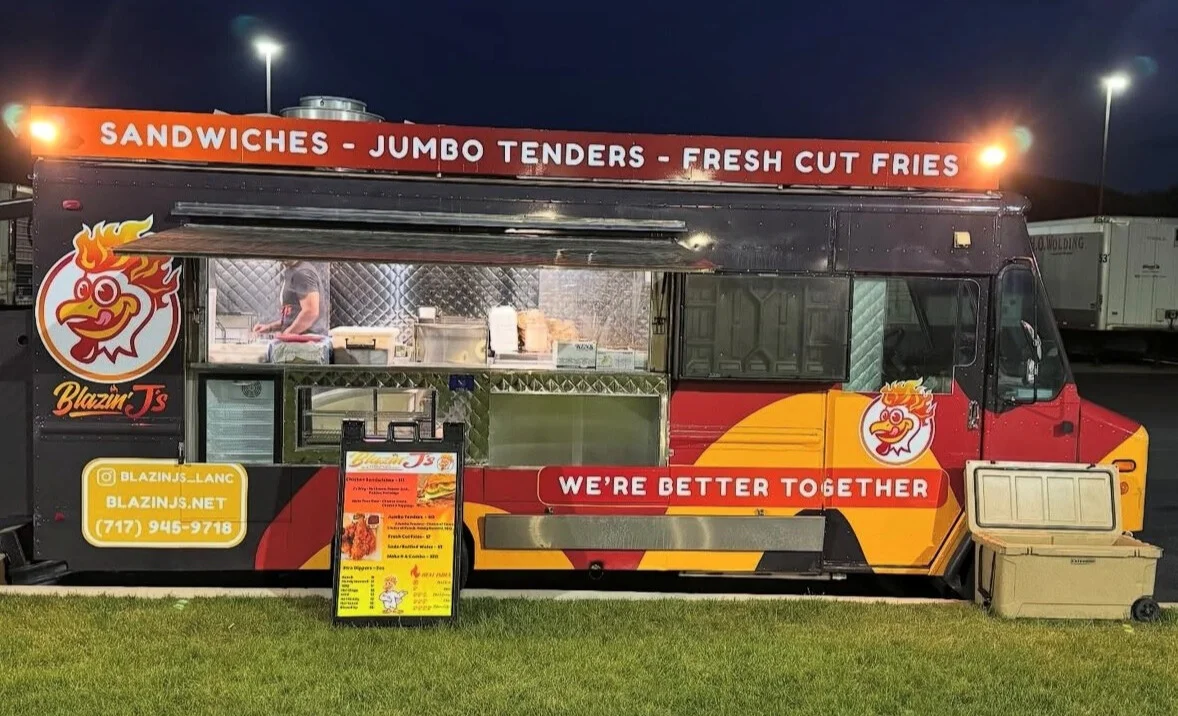 Food truck serving sandwiches and jumbo tenders at night