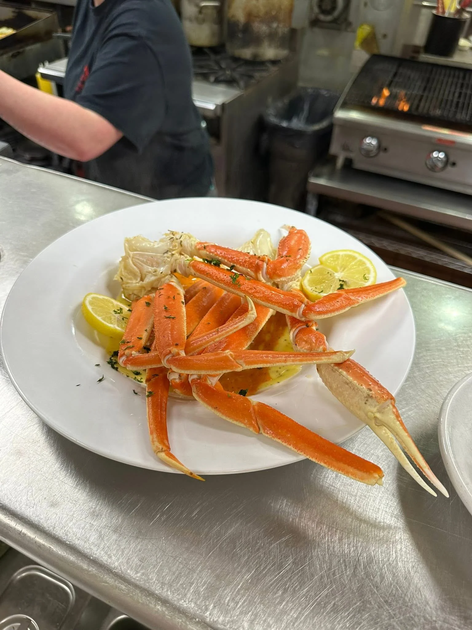 Plate of steamed crab legs with lemon wedges