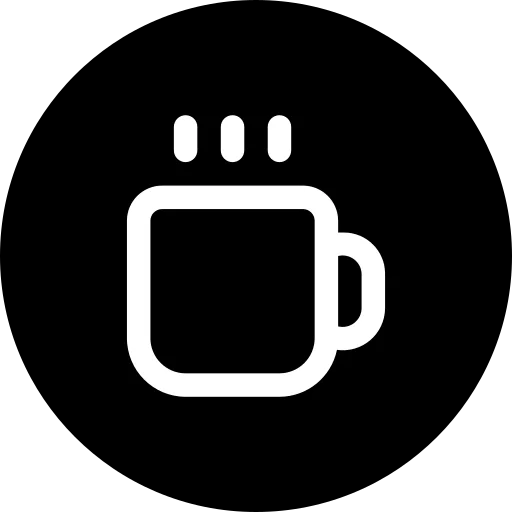 A steaming mug of hot beverage on a wooden table.